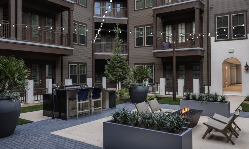 a courtyard with ample seating and fire pit