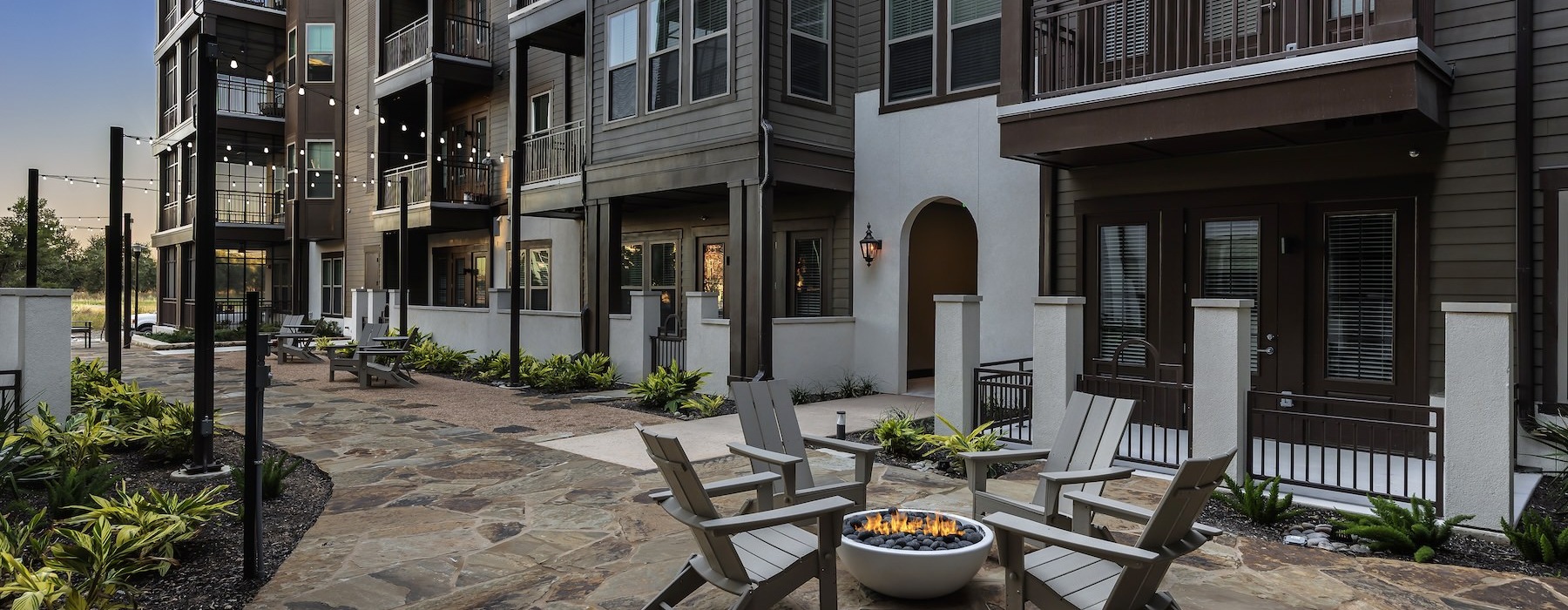 a courtyard with a walking path and fire pit