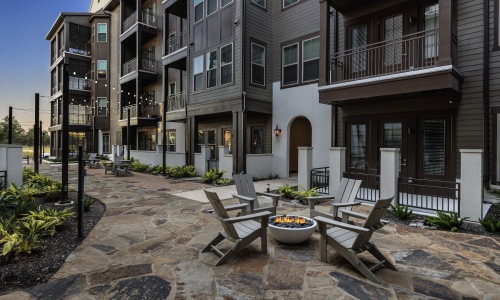 a courtyard with a walking path and fire pit